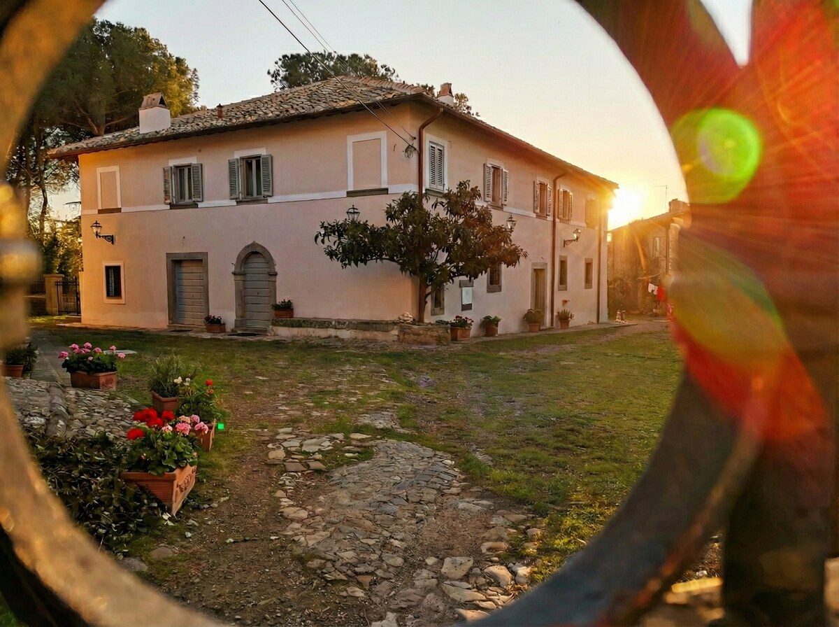 The villa seen from the entrance gate at sunset
