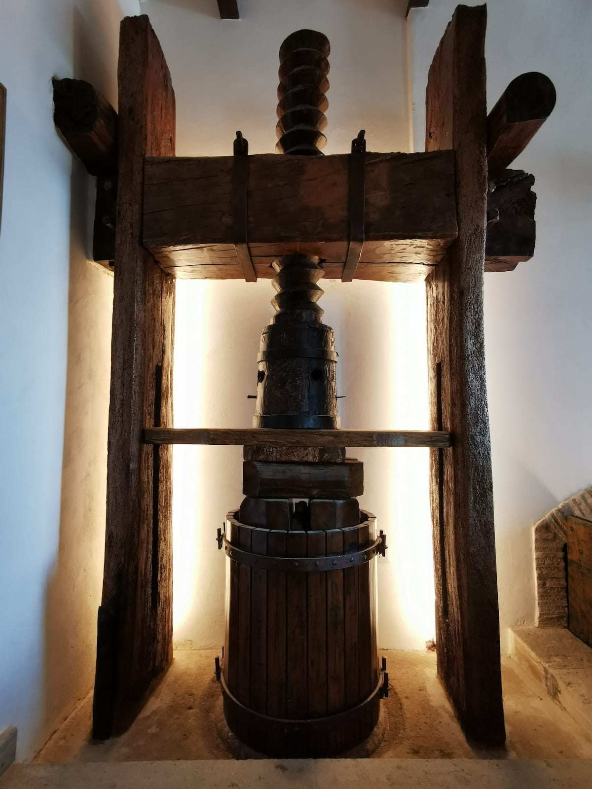 The antique wooden wine press kept inside the house